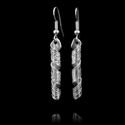 These sterling silver dangle earrings have spiral hangs with depictions of the Raven carved into them.