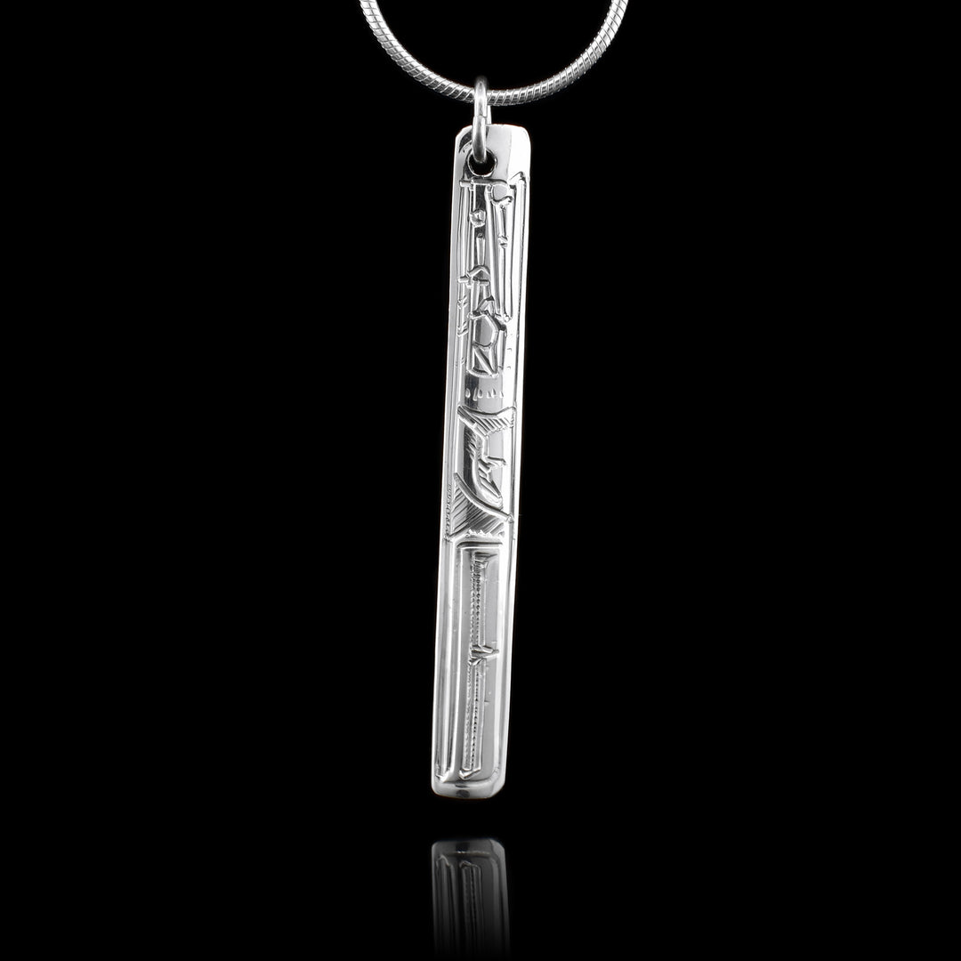 This sterling silver pendant is thin and rectangular. There is a depiction of the Raven carved into the pendant.