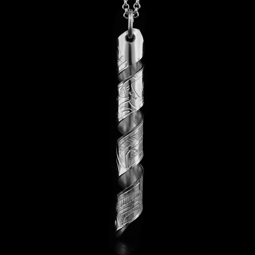 This Bear spiral pendant is made out of a sterling silver strip which has the face and body of the Bear carved on it and then coiled into a spiral.