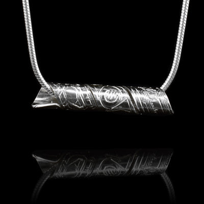 This sterling silver pendant is made form a band that has been shaped into a spiral. There is a depiction of the Thunderbird carved into the surface of the pendant.