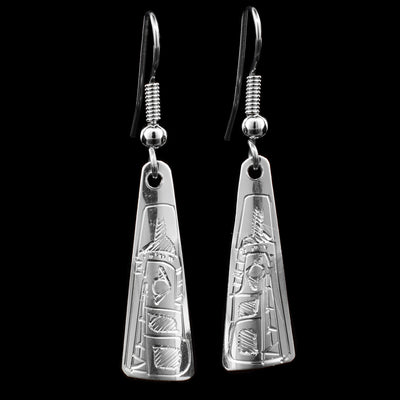 These triangular drop earrings are made from sterling silver and have long triangular hangs with rounded edges. There are beautiful carvings on the surface of the hangs depicting the Wolf.