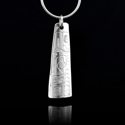 This Wolf pendant is made from sterling silver and is rectangular and slight tapered. There is a depiction of the Wolf carved into the surface of the pendant..