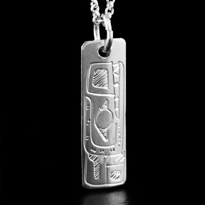 This pendant is made out of sterling silver. It is rectangular and has the face of the Wolf handcarved at the top. The Wolf is facing upwards.