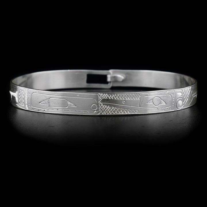 This sterling silver bracelet has the heads of the Orca and the Hummingbird carved on the front, facing each other. Their bodies are engraved on the rest of the bracelet.