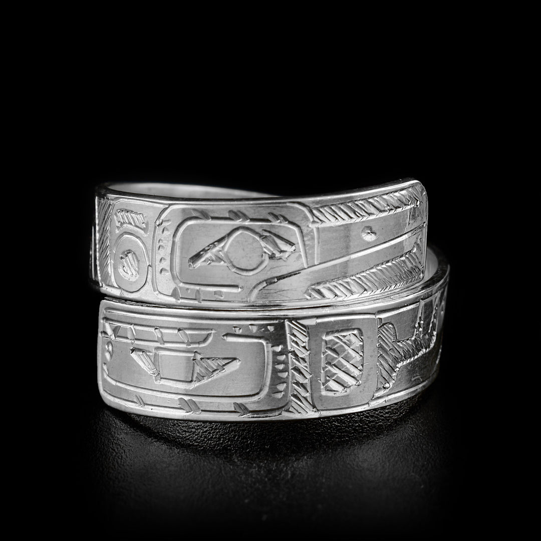 The two ends of this sterling silver wrap ring overlap in the front.One of the ends has an Orca face engraved on it, and the other has a Hummingbird.