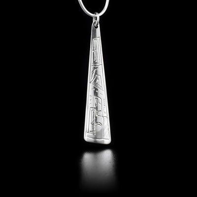 This sterling silver pendant is long, thin, and wider at the bottom. A depiction of the Eagle is carved into it.