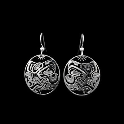 These Salmon, Frog and Eagle earrings are made from sterling silver and there are oval hangs. The hangs have cutout depictions of the Eagle, the Salmon, and the Frog cast into them.