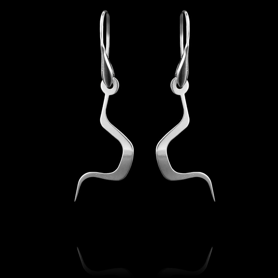 These sterling silver dangling earrings drop down and have thin, curvy hangs. The pieces curve in sharply and make a round section in the center of them. The hangs represent a Haida Gwaii character.