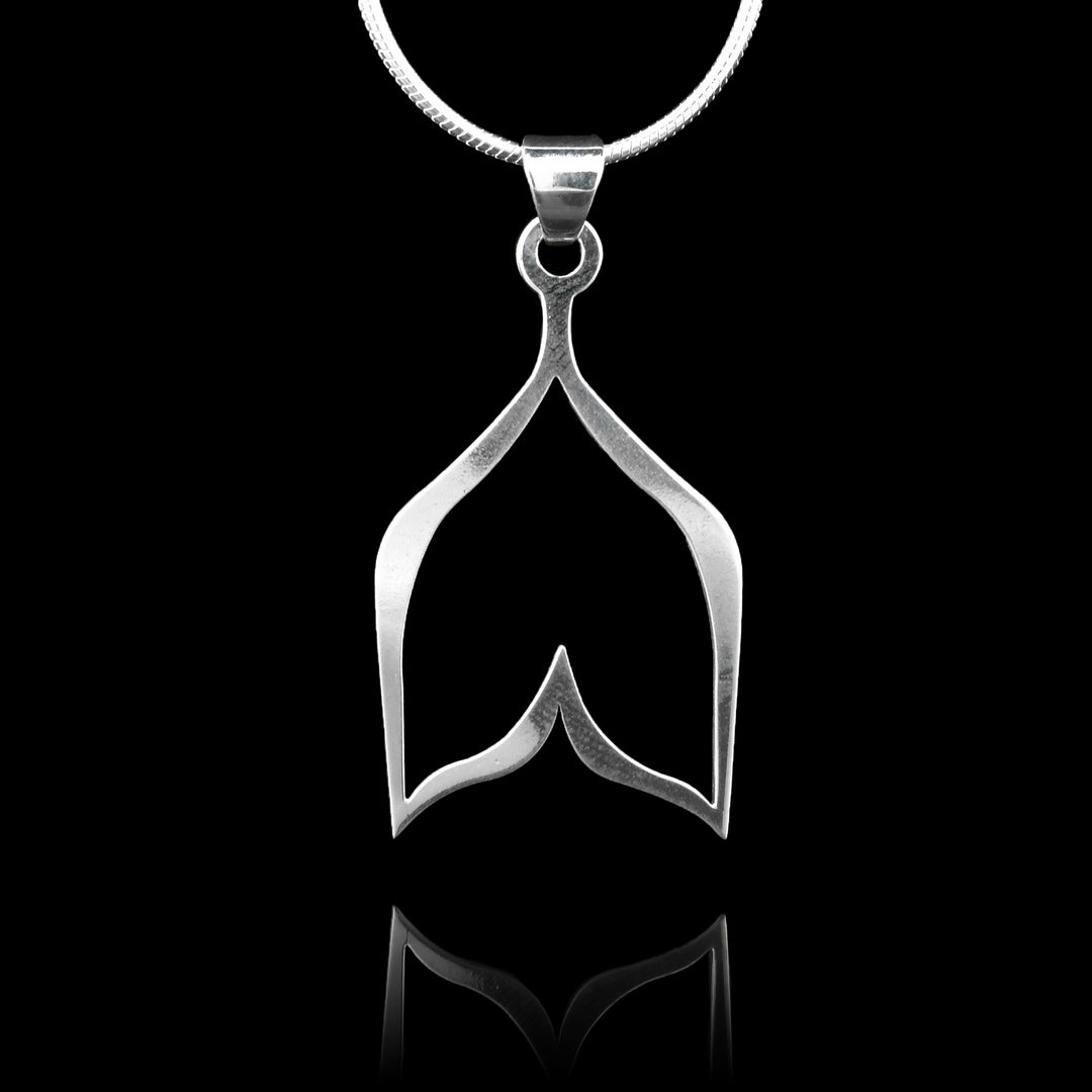 These sterling silver pendants are shaped like a wide, whale-tail design with a cutout in the middle. The piece represents a Haida character.