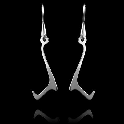 These sterling silver long dangling earrings have thin hangs that drop down and have points protruding from them to make a curvy, L-shaped. The hangs depict a Haida Gwaii character.
