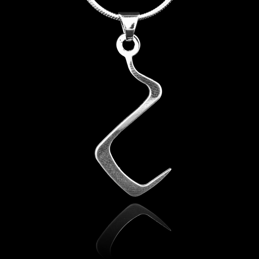 These sterling silver pendants are thin and curved in a zig-zag shape with the bottom curving into a hook shape. The piece represents a Haida Gwaii character.