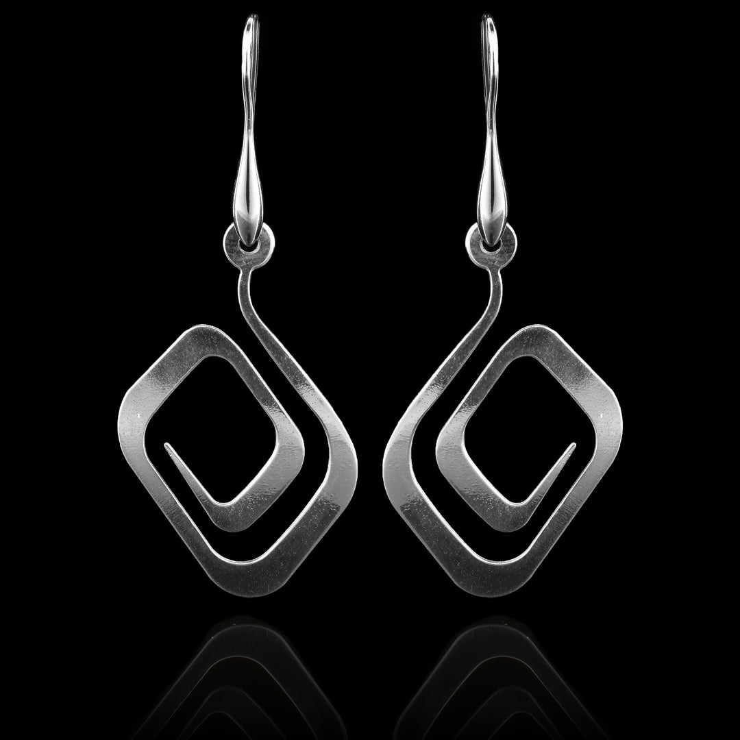 These sterling silver dangling spiral earrings have thin hangs that curved into a round shape and depict a Haida Gwaii character.