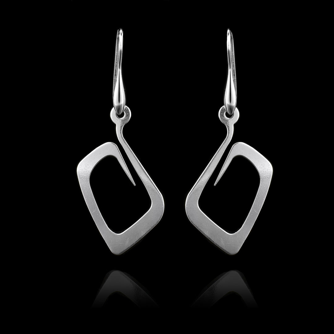 These sterling silver dangling earrings have thin hangs that curved into a round shape and depict a Haida Gwaii character.