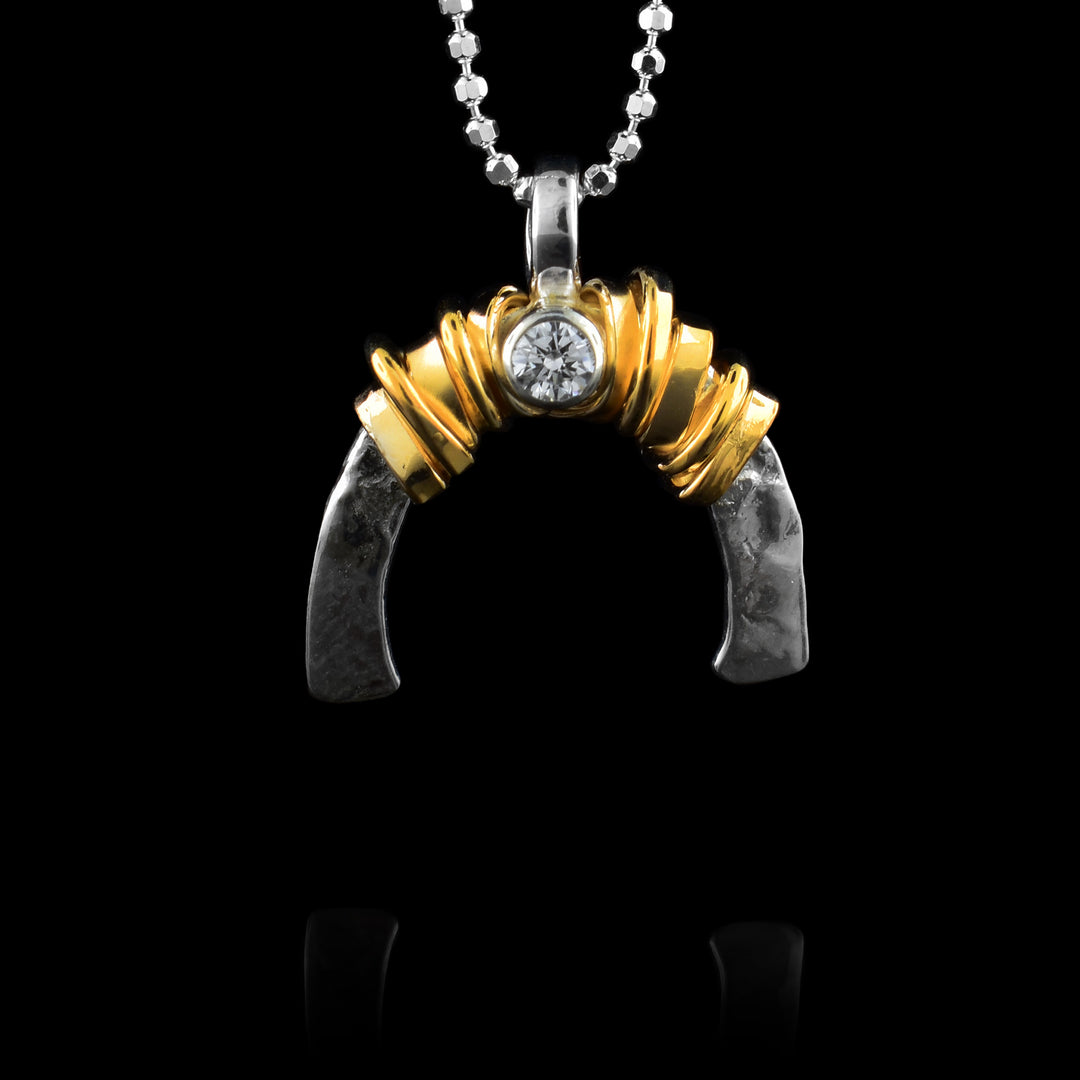 Gold-fill wrap around sterling silver  arch with a cubic zirconia in the middle.