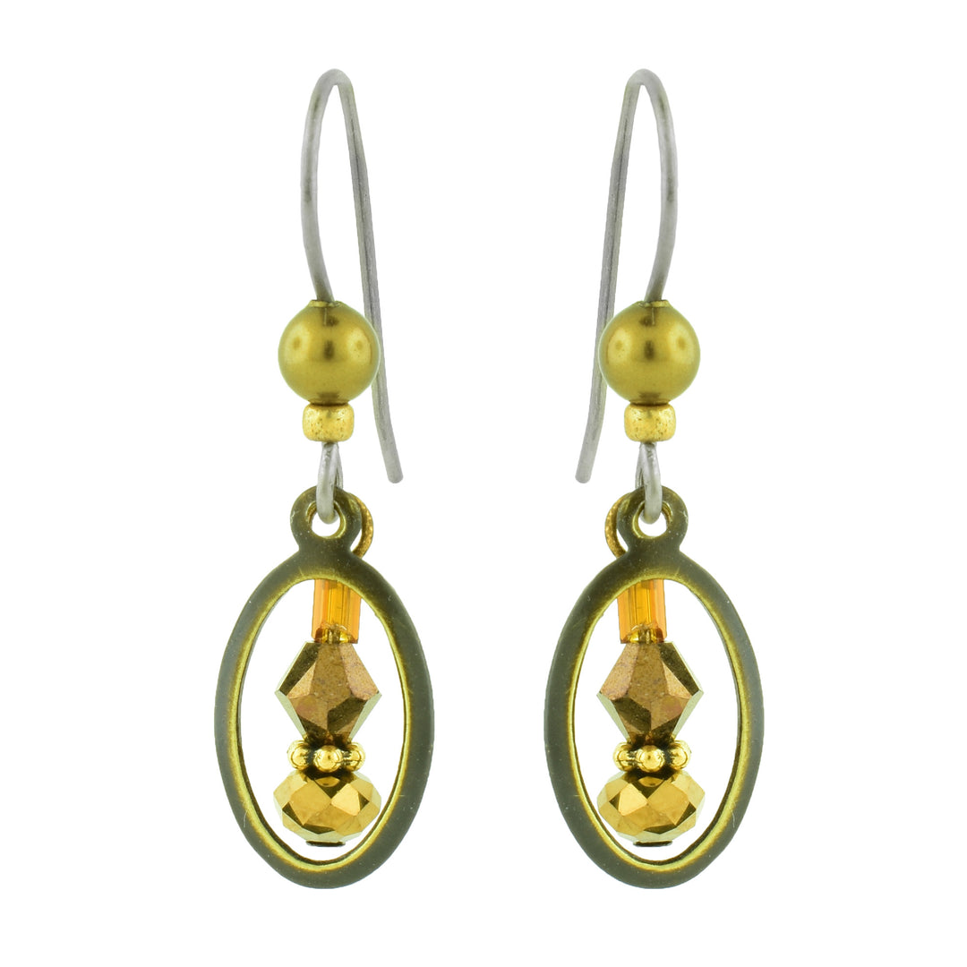 these antique brass-finished drop earrings by artist Honica. Featuring a sleek geometric oval frame surrounding intricate glass beads.