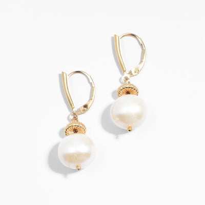 Gold-fill lever-back dangle earrings featuring two round, white freshwater pearls.