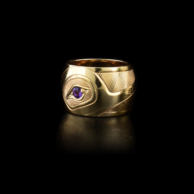 14K yellow gold spirit bead featuring side-view of hummingbird head with amethyst set in eye. Finely carved lines in background.