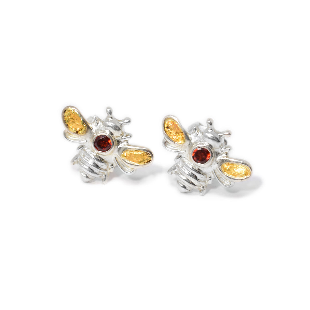 Sterling silver bee studs with 22K gold nuggets in wings. Both bees have a round, faceted garnet set on the back. Handcrafted by Tom Gregorczyk.
