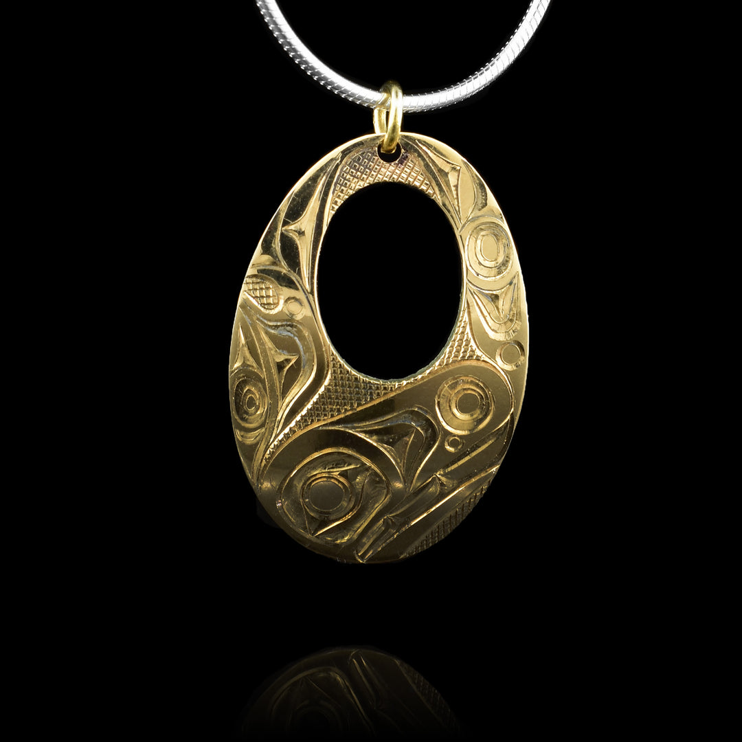 his handcrafted 14K gold pendant by Haida artist Jim McGuire features a finely carved Orca design, symbolizing strength, unity, and the spirit of the ocean. A striking piece of Northwest Coast Indigenous art.