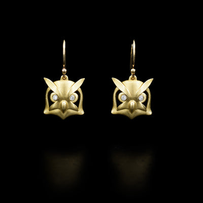 14K yellow gold owl heads with Canadian diamonds in the eyes dangle from hooks. Handcrafted by Dennis Kangasniemi.