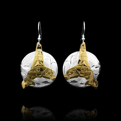 This Silver and Gold-Plated Orca Earrings are hand carved by Tlingit artist, Fred Myra. Fred has carved the silver piece first and then applied 18K gold-plating on it.