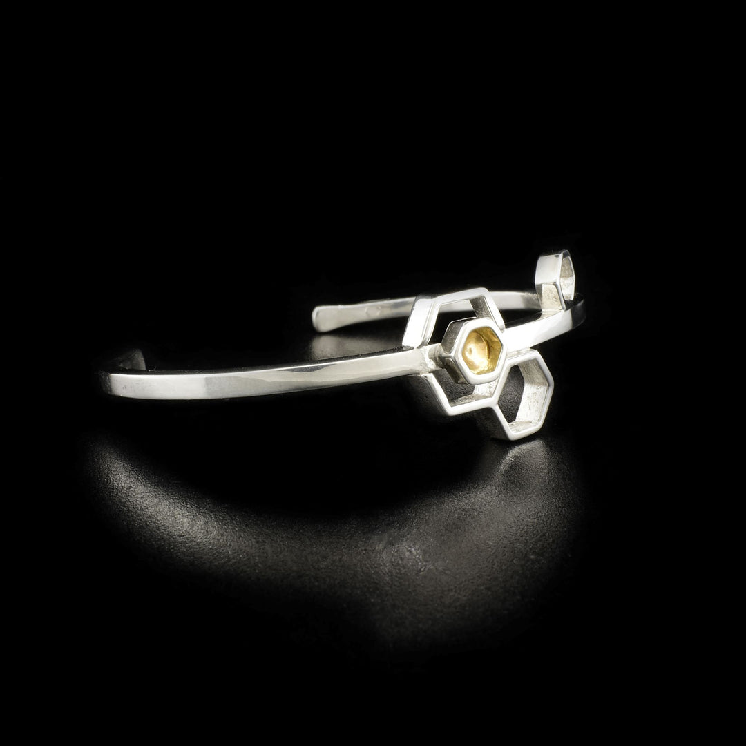 Side/front view of bracelet with hexagon containing 14K gold shown.
