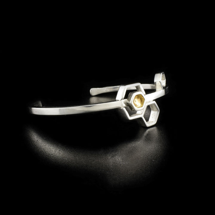 Side/front view of bracelet with hexagon containing 14K gold shown.