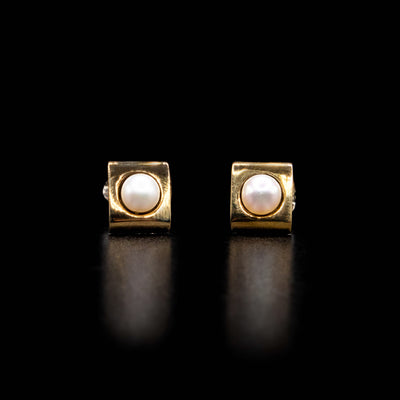 White freshwater mabé pearls set in 14K yellow gold squares. By Ivan Dobren.