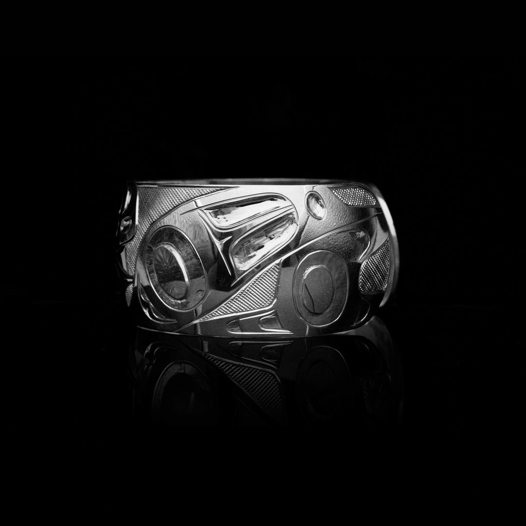 Carved designs with cross-hatching background.