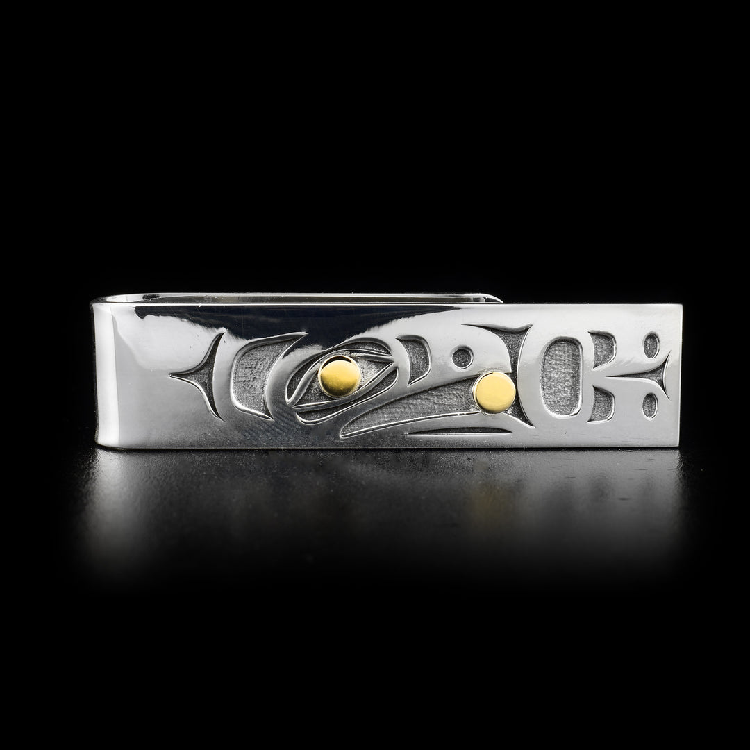 Sterling silver money clip featuring raven with 14K yellow gold ball in beak and eye. The Raven is facing the opening with its wing spread out.