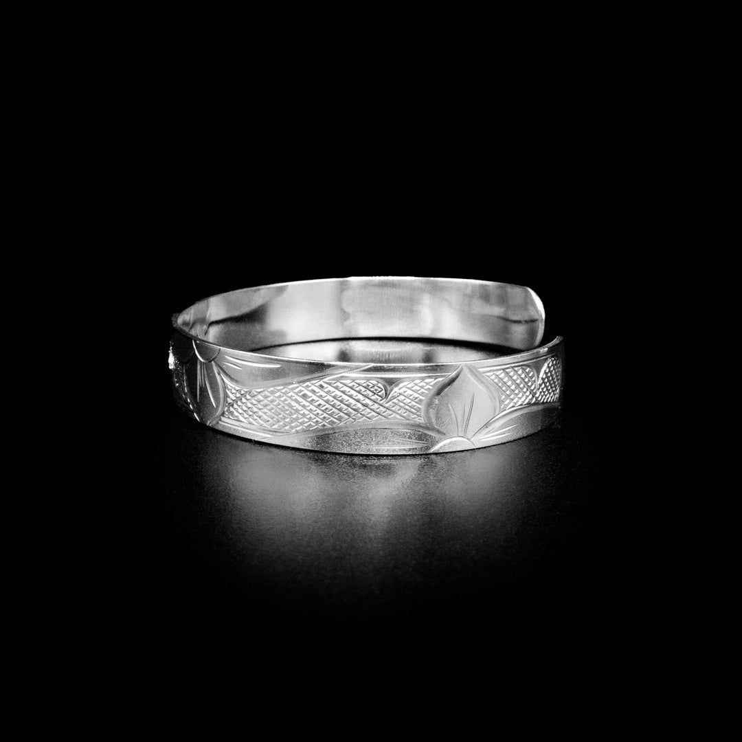 Left side of bracelet with flowers and cross-hatching background.