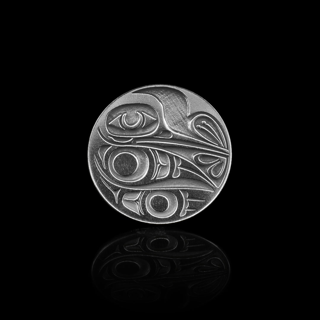 This sterling silver golf marker is a perfect circle and inside is a handcarved hummingbird.