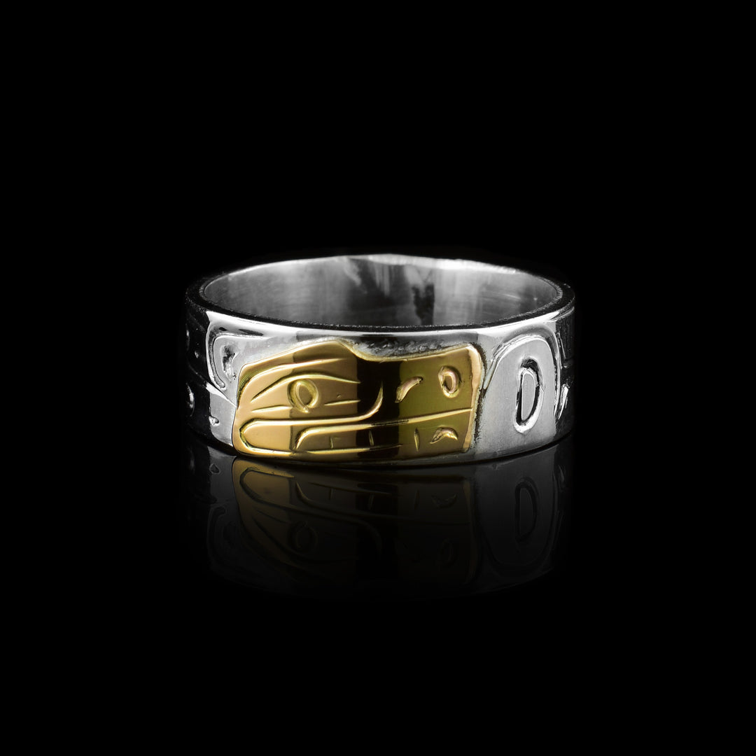 his authentic Graham Henry Bear Band ring. Features a hand-carved sterling silver band with a striking 10K gold Bear inlay. A masterpiece of Indigenous artistry.