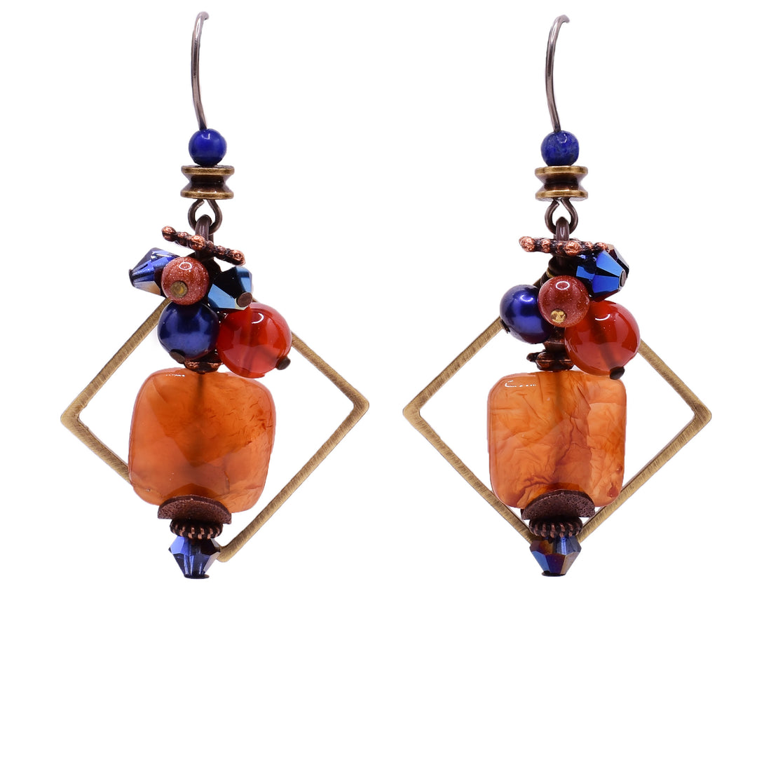 Dangle drop earrings made of Swarovski crystal, handworked brass, lapis lazuli, carnelian agate, red goldstone, pearls and jasper. Titanium hooks. By Honica.