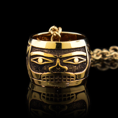 This 14K gold charm bead has depictions of a chilkat box across the surface of it.