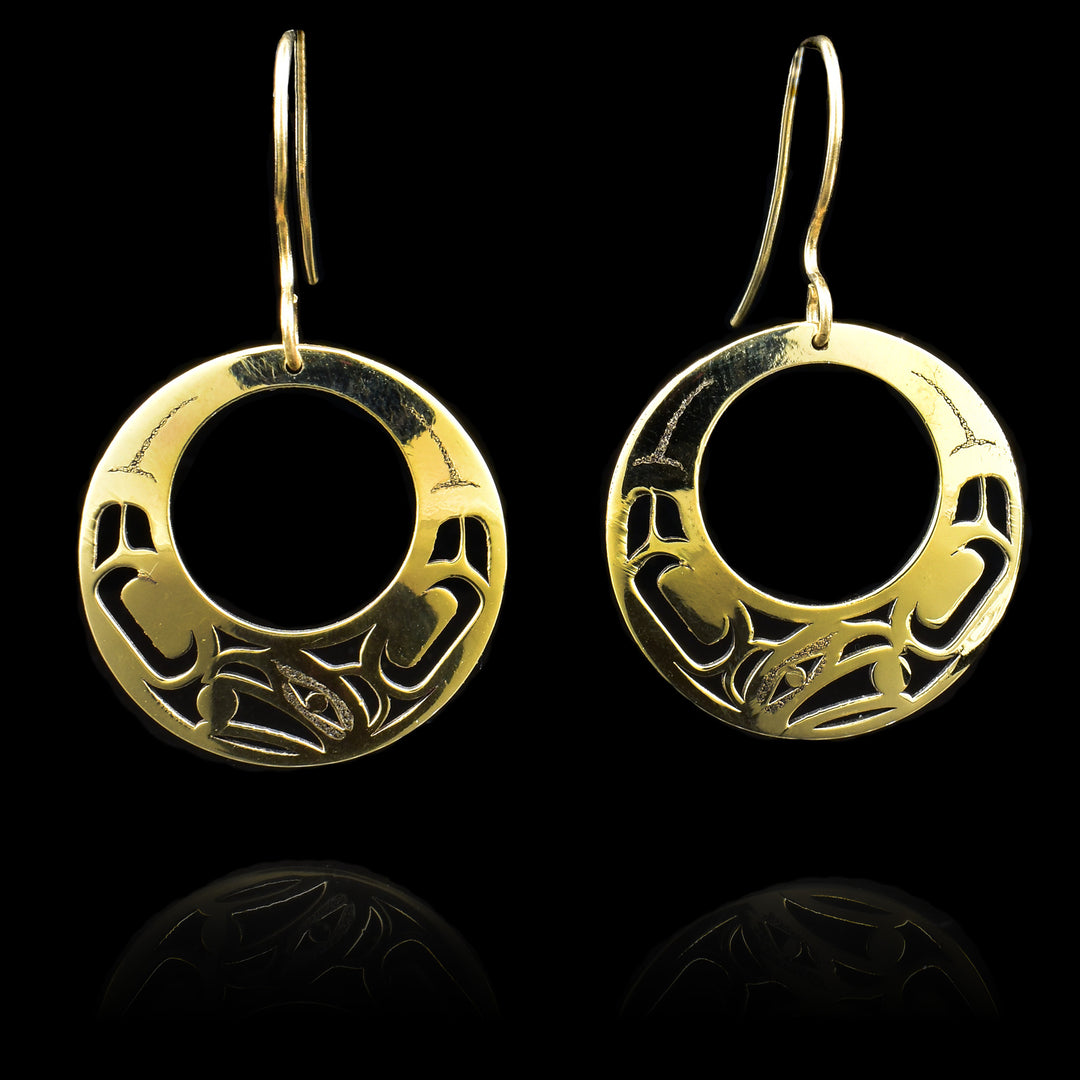 These Eagle earrings are made from 14K gold and have large circle shaped hangs. There are cutout depictions of the Eagle that have been cast into the surface of the hangs.
