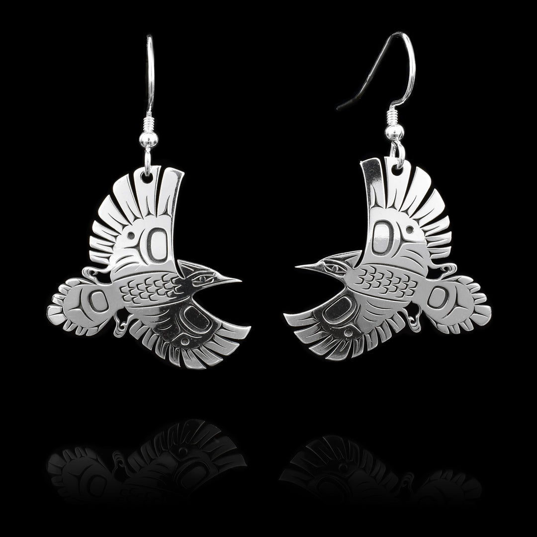 These sterling silver dangle earrings have hangs that features a cutout design that depicts stellers' jays in mid-flight.