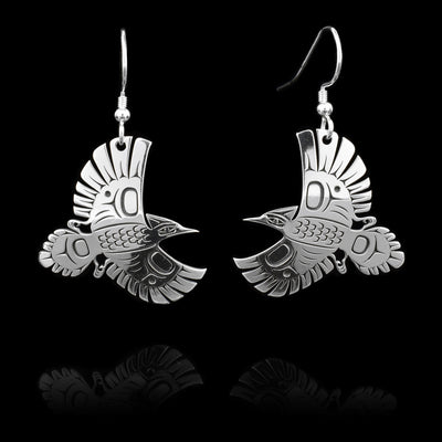 These sterling silver dangle earrings have hangs that features a cutout design that depicts stellers' jays in mid-flight.