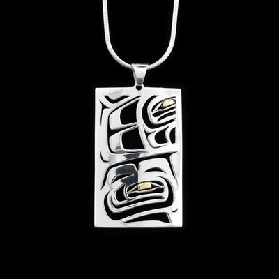 This gorgeous Raven pendant is made from sterling silver and 18K gold. It is rectangle shaped and has cutout designs that depict the Raven on the surface of the pendant. The eyes of the pendant are made from 18K gold.