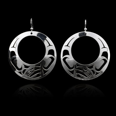 These Eagle earrings are made from sterling silver and have large circle shaped hangs. There are cutout depictions of the Eagle that have been cast into the surface of the hangs.