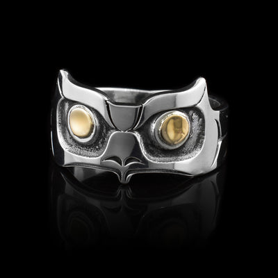 This gold and silver ring has been made using sterling silver and 14K gold and has a single band that becomes more wide at the top of it. There is a depiction of the head of the Owl that has been cast into the surface of the wide portion of the ring. The designs are deep and the eyes of the Owl are made using the gold.