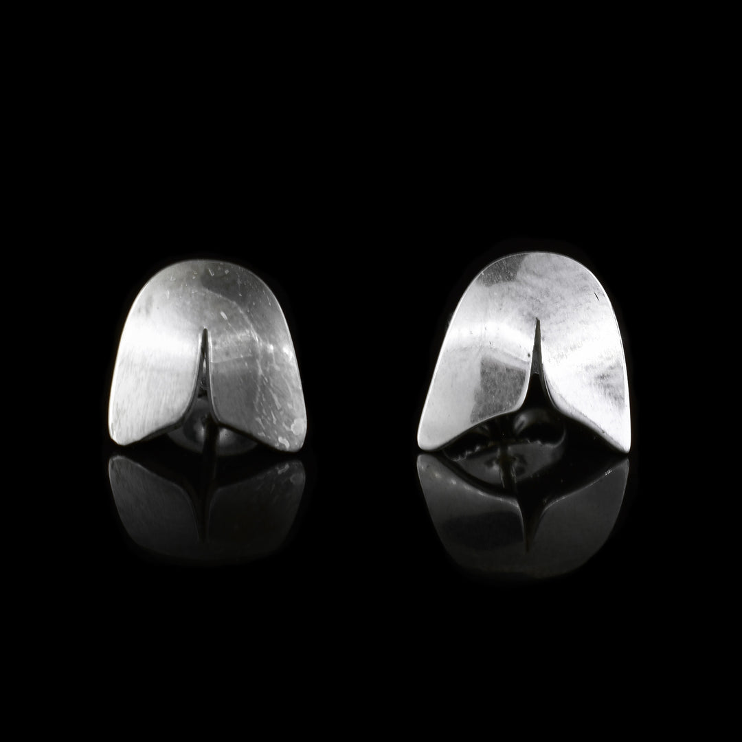 These sterling silver stud earrings have an oval shape with a slit in the center that is shaped like the dorsal fin of the Orca.