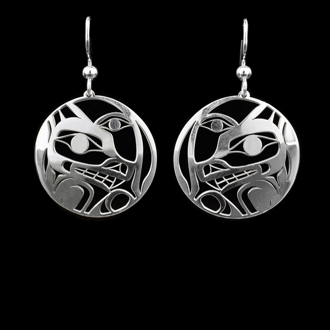 These dangling Wolf and Moon earrings are made from sterling silver and have circle shaped hangs. There are cutout designs depicting the Wolf and the Moon on the hangs.