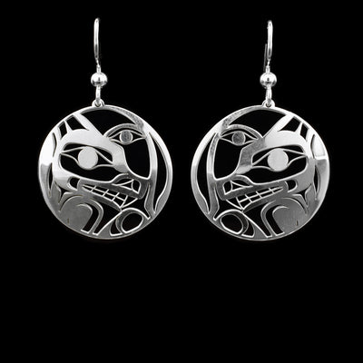 These dangling Wolf and Moon earrings are made from sterling silver and have circle shaped hangs. There are cutout designs depicting the Wolf and the Moon on the hangs.