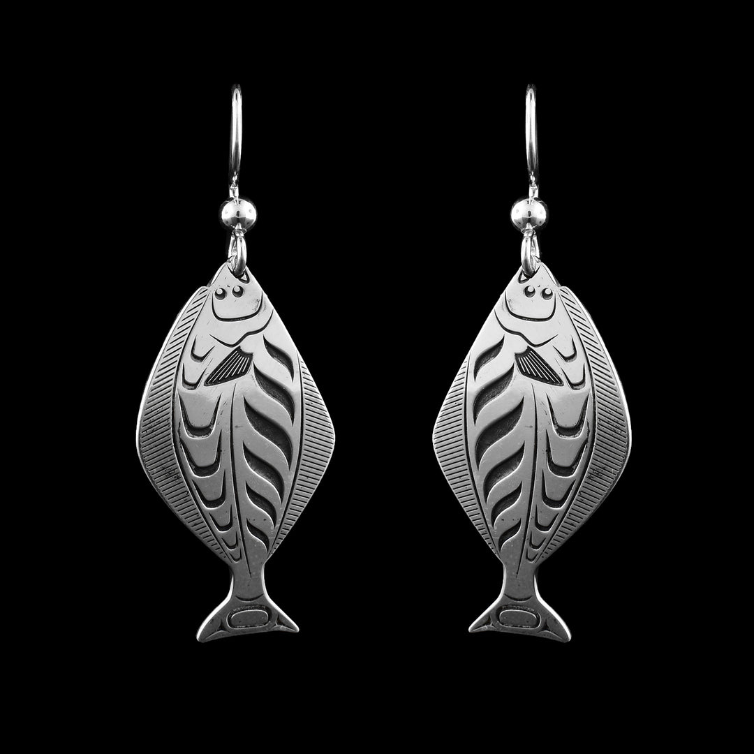 These sterling silver Halibut dangle earrings are cut to the shape of the halibut. Engraved on the earrings is detailing of the Halibut so you can make out details of the body. 