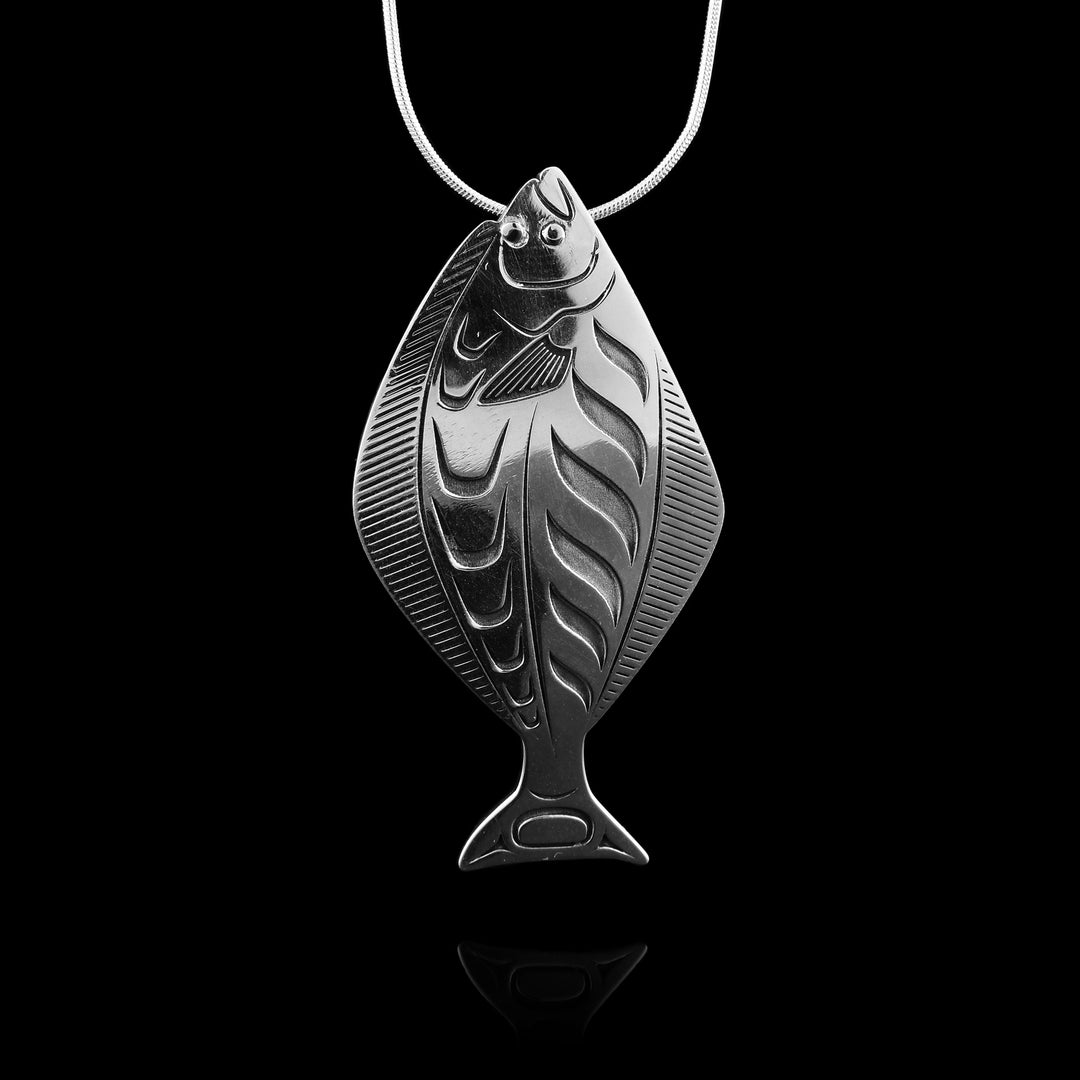 this Grant Pauls sterling silver Halibut pendant. Hand-carved by the Tahltan artist, precise engravings that capture the lifelike spirit of the Halibut in stunning detail.