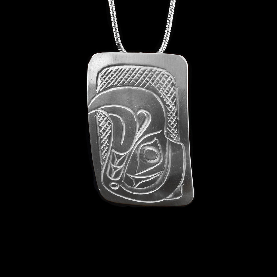 Hand carved rectangle Eagle pendant by Kwakwaka’wakw artist Don Lancaster, with a design depicting the Eagle legend. Authentic Northwest Coast art.