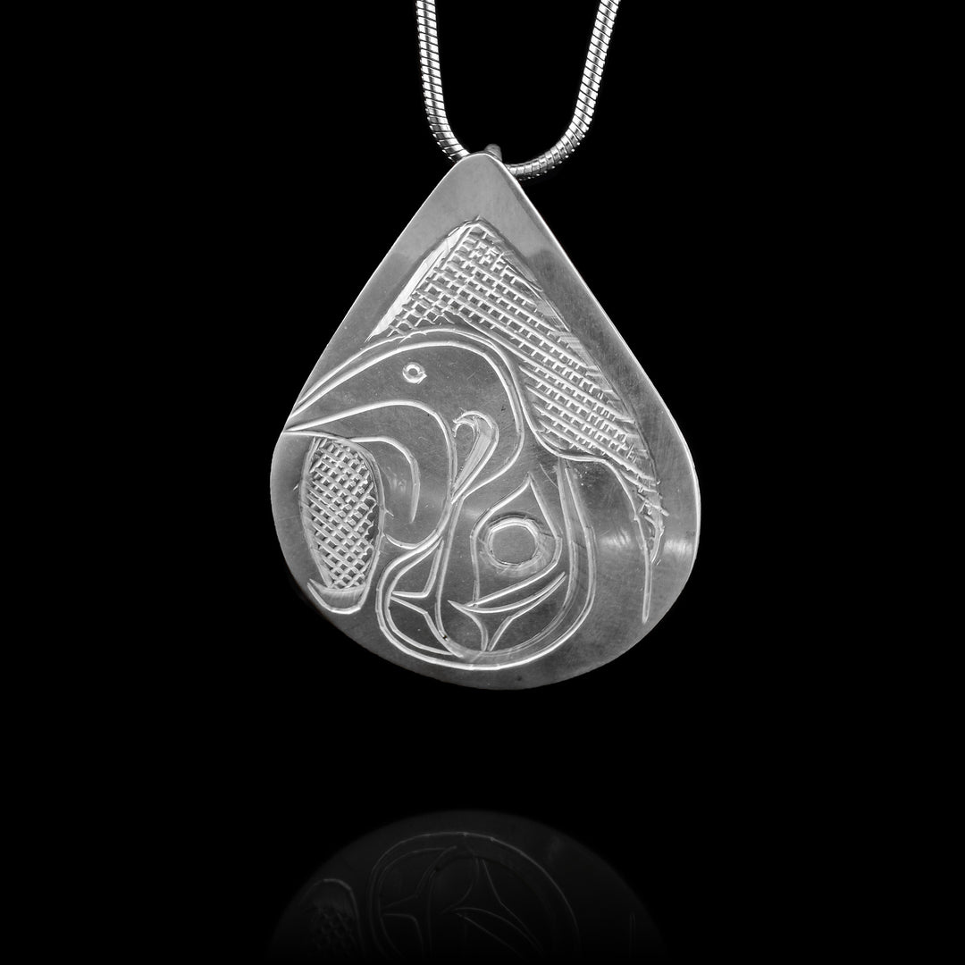 Hand carved Eagle head pendant by Kwakwaka’wakw artist Don Lancaster, with a teardrop design depicting the Eagle legend. Authentic Northwest Coast art.
