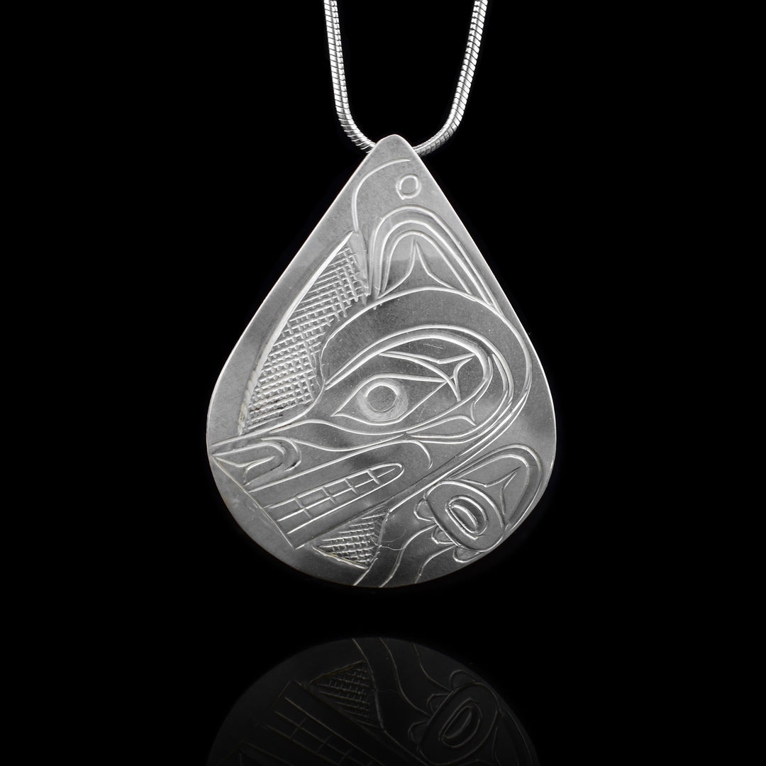 Hand carved Wolf head pendant by Kwakwaka’wakw artist Don Lancaster, with a teardrop design depicting the Wolf legend. Authentic Northwest Coast art.