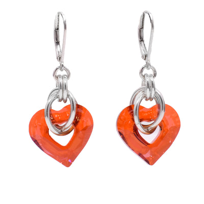 These Swarovski crystal earrings feature orange heart shaped Swarovski crystals with two silver loops going through each earrings. Includes silver leverback clips.